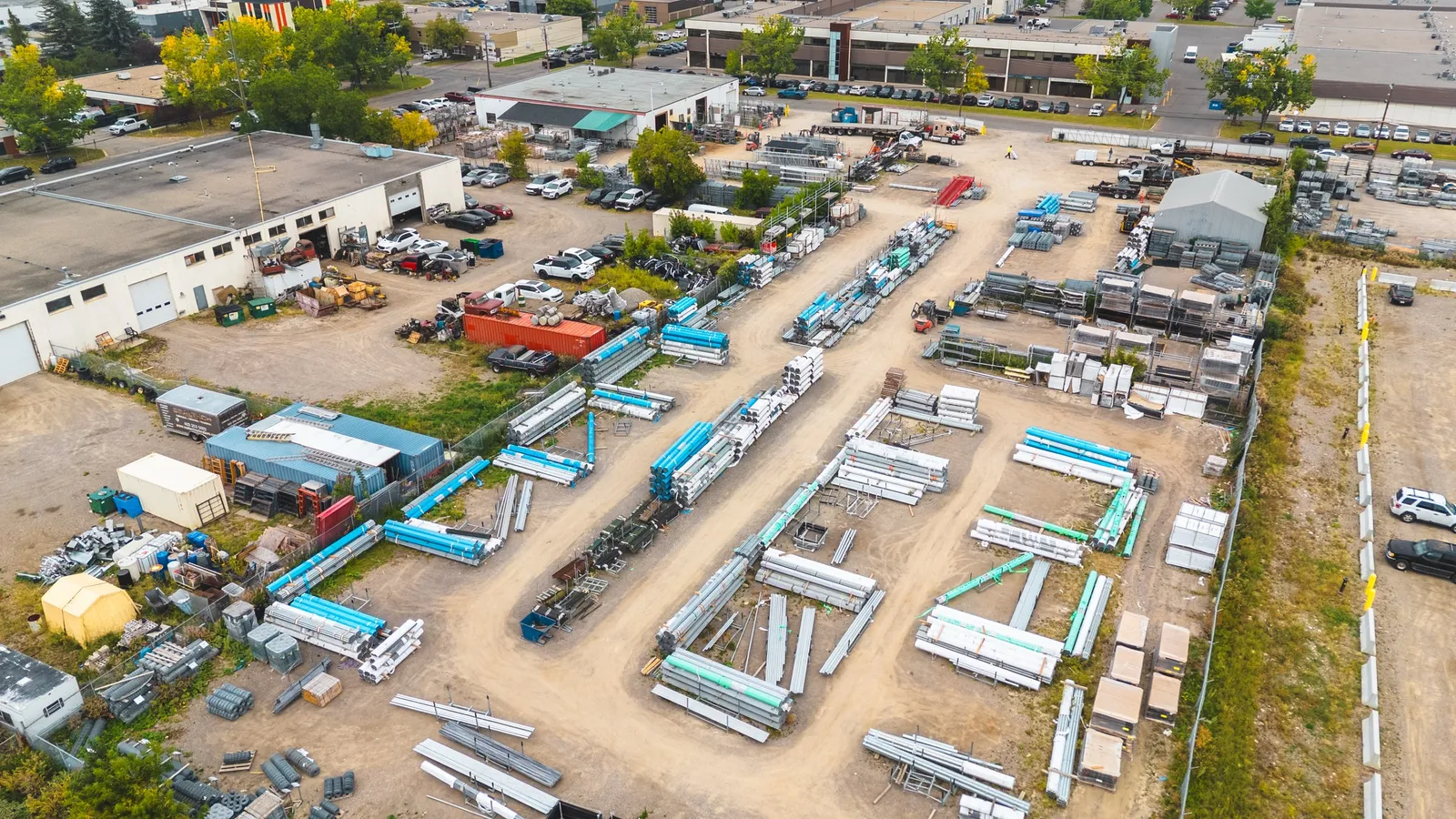 Aerial view of pipe, tube and fence inventory laid out across the Phoenix Fence Calgary yard