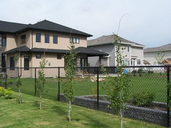 Black coloured chain link fence and gate at a residence