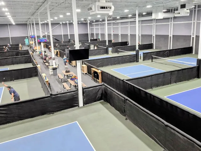 Indoor pickleball courts divided by chain link fence, Edmonton Pickleball Center