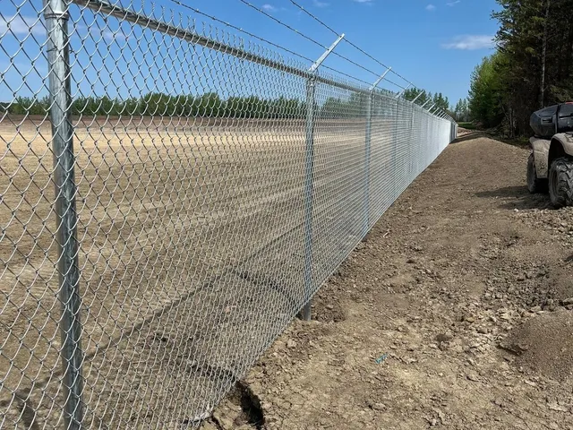 Galvanized chain link perimeter under construction