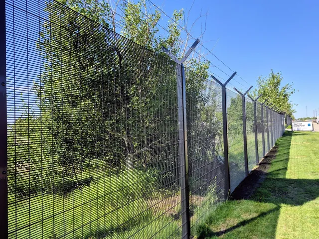 Black welded mesh fence line with barbed wire, Kennedale Eco Station