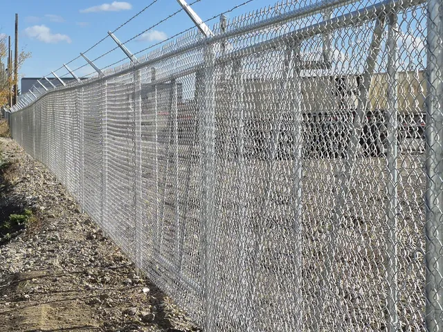 Galvanized chain link with barbed wire, Skyline Trucking