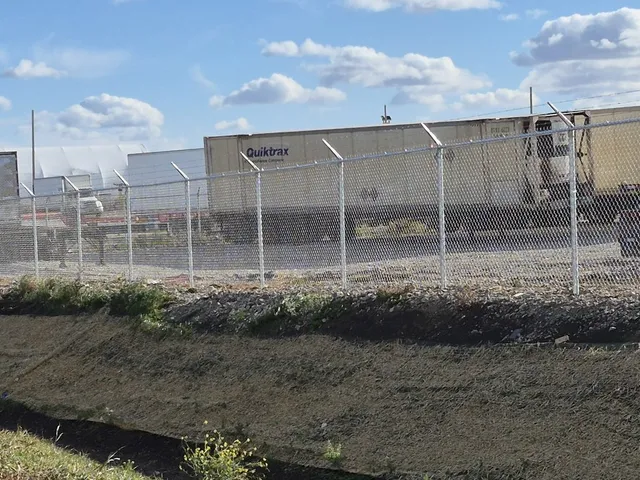 Galvanized chain link yard fence with barbed wire, Skyline Trucking