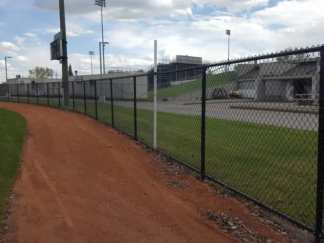 Ball diamond perimeter fence, black chain link