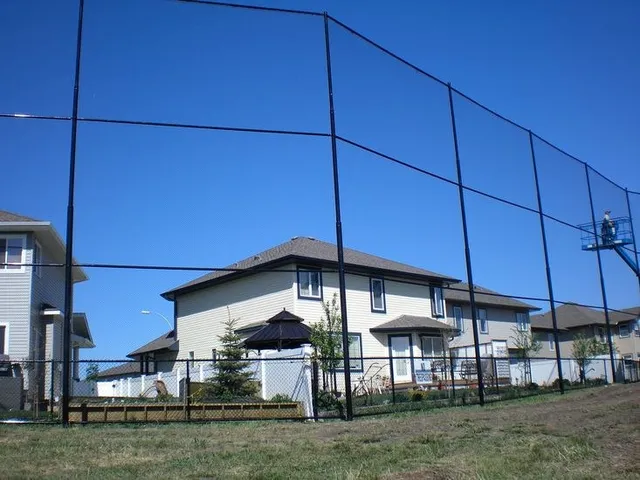 Golf course fence beside homes