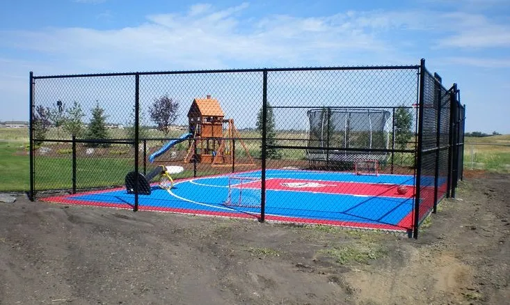 Black chain link fence around a playground and sport court