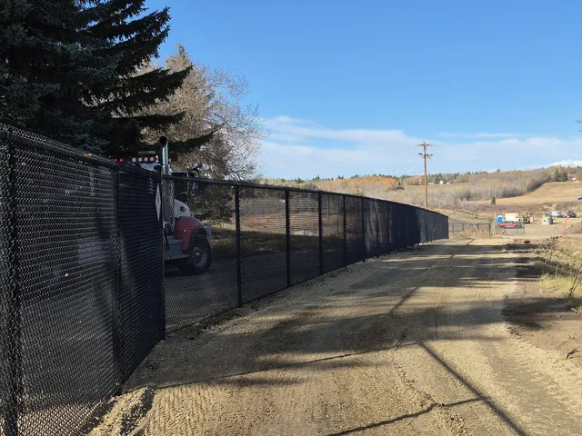 Black chain link golf course fence beside the access road, Sturgeon Golf Course
