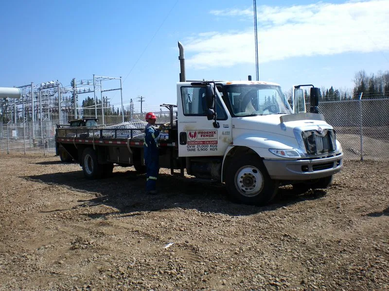 Phoenix Fence crew and truck at an industrial site