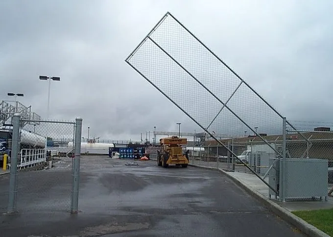 Vertical pivot gate raised open at an industrial site entrance