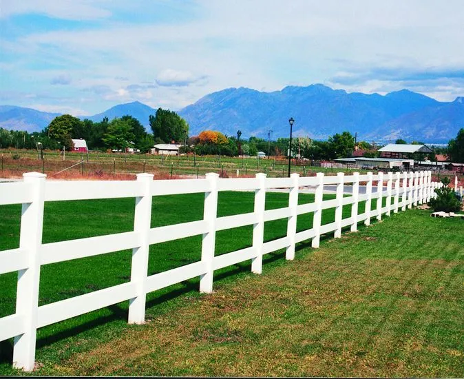 White three rail ranch vinyl fence along a pasture