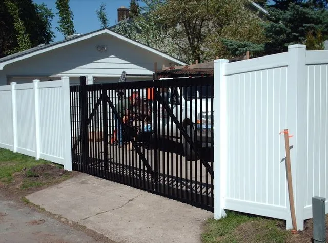 White vinyl fence with ornamental gate